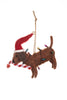 A brown felt dachshund Christmas ornament wearing a red Santa hat and wrapped in multicolored holiday lights, holding a candy cane, on a white background.