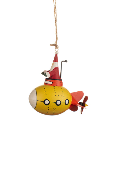 A whimsical Christmas ornament shaped like a yellow submarine with a Santa hat, hanging from a thin string against a plain white background.