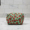 Washbag with green and red watermelon print on a gray surface