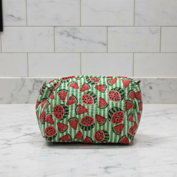 Washbag with green and red watermelon print on a gray surface